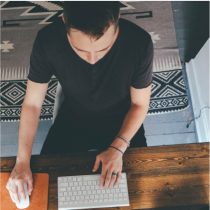 Image of person working at desk on a computer